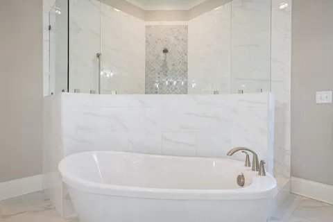 an aerial view of a house with swimming pool and large trees