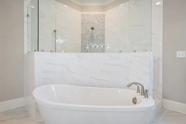 an aerial view of a house with swimming pool and large trees