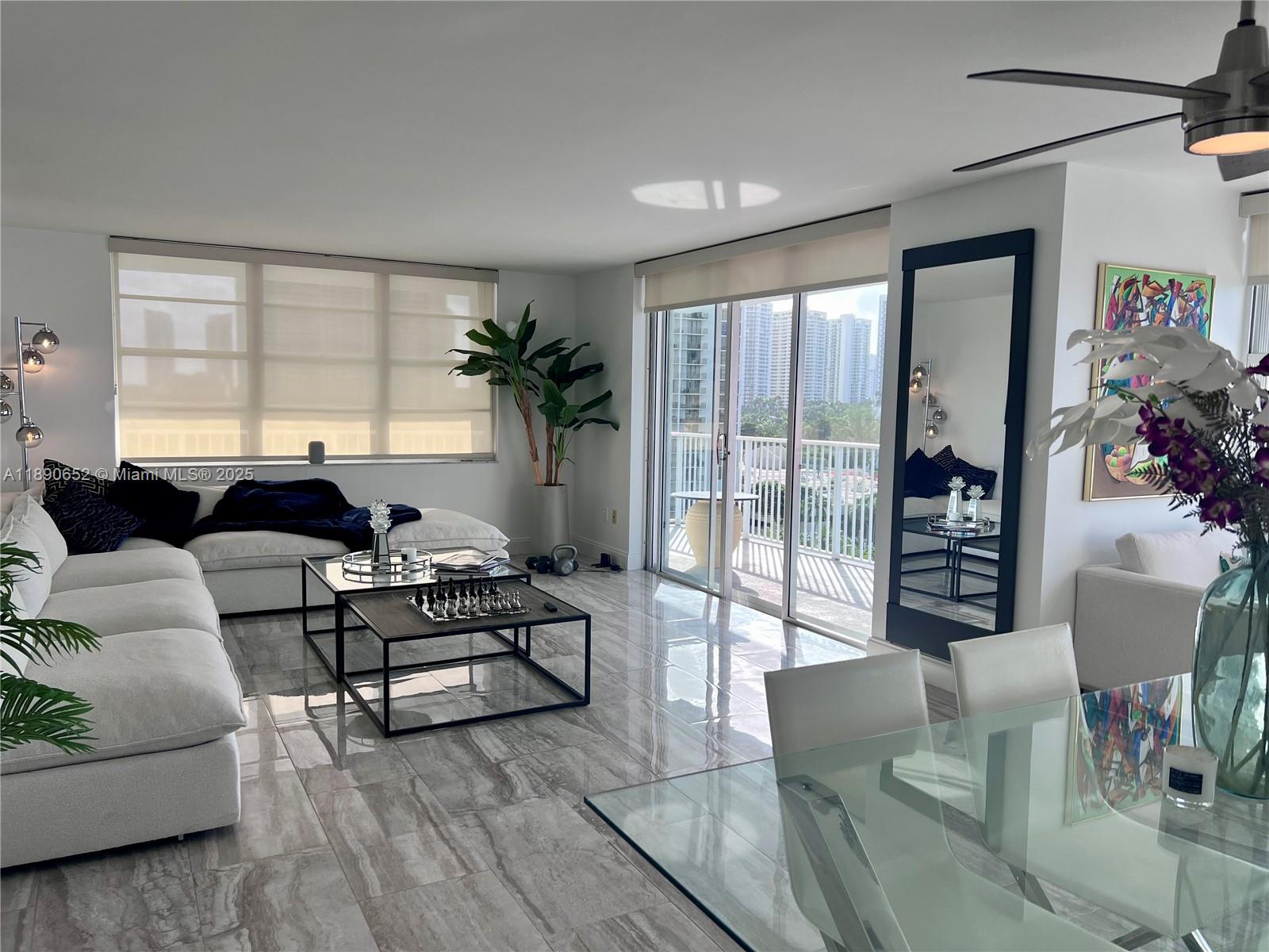 2851 Northeast 183rd Street, Unit 1017E Aventura, FL 33160 - Photo 13 of 46 a living room with furniture and a large window
