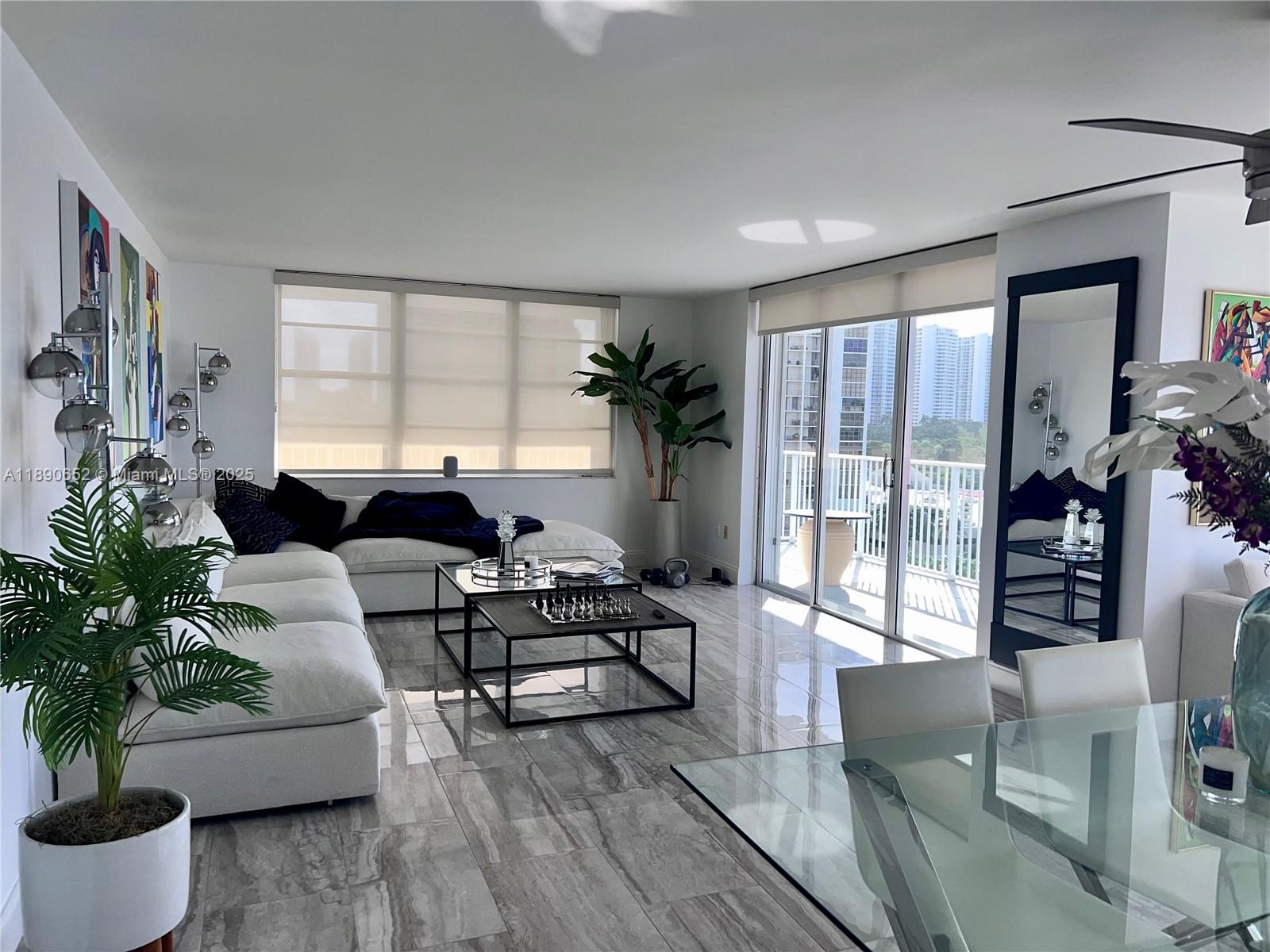 2851 Northeast 183rd Street, Unit 1017E Aventura, FL 33160 - Photo 15 of 46 a living room with furniture and a large window