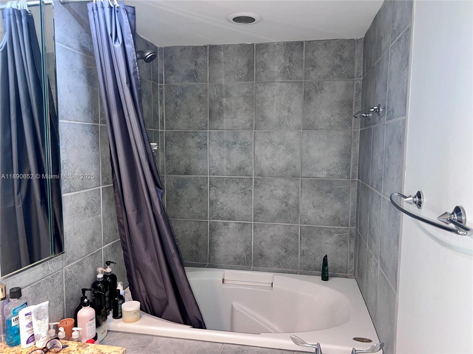 2851 Northeast 183rd Street, Unit 1017E Aventura, FL 33160 - Photo 26 of 46 a bathroom with a tub