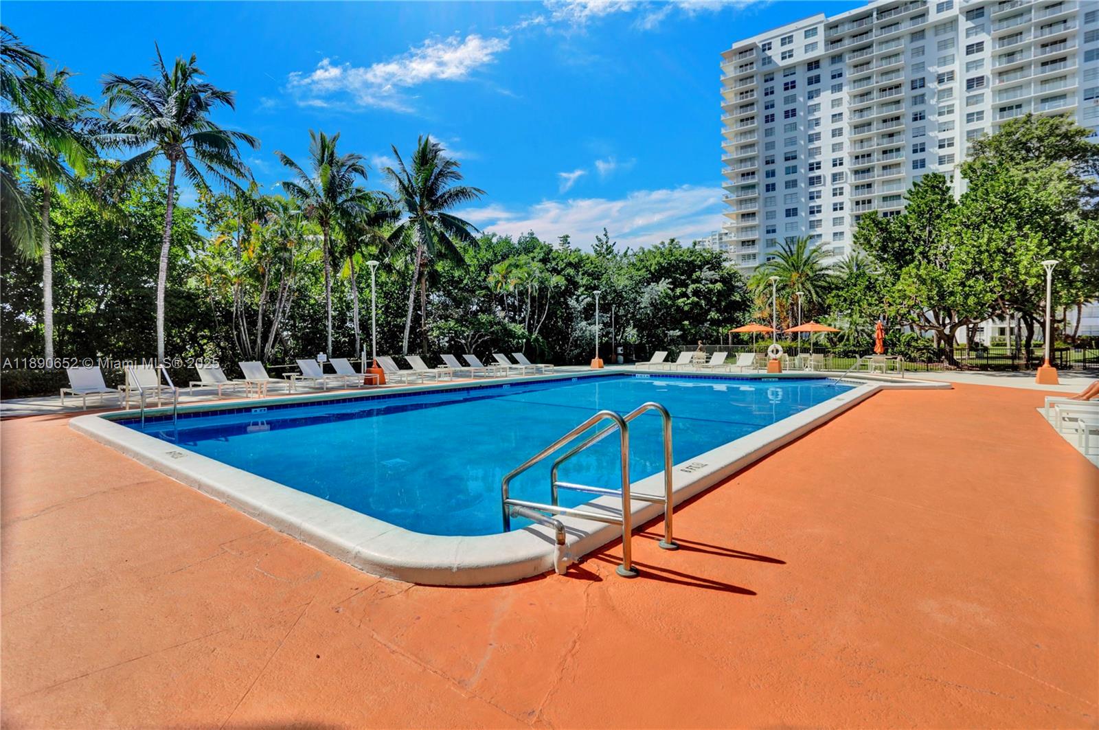 2851 Northeast 183rd Street, Unit 1017E Aventura, FL 33160 - Photo 36 of 46 a swimming pool with outdoor seating and yard