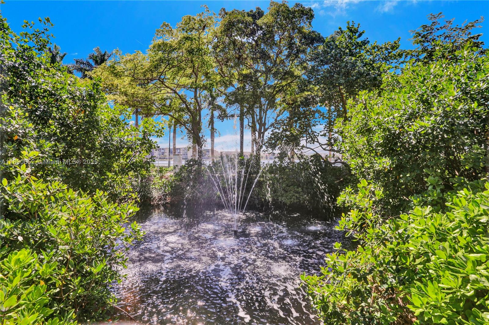 2851 Northeast 183rd Street, Unit 1017E Aventura, FL 33160 - Photo 42 of 46 a backyard of a house with lots of green space