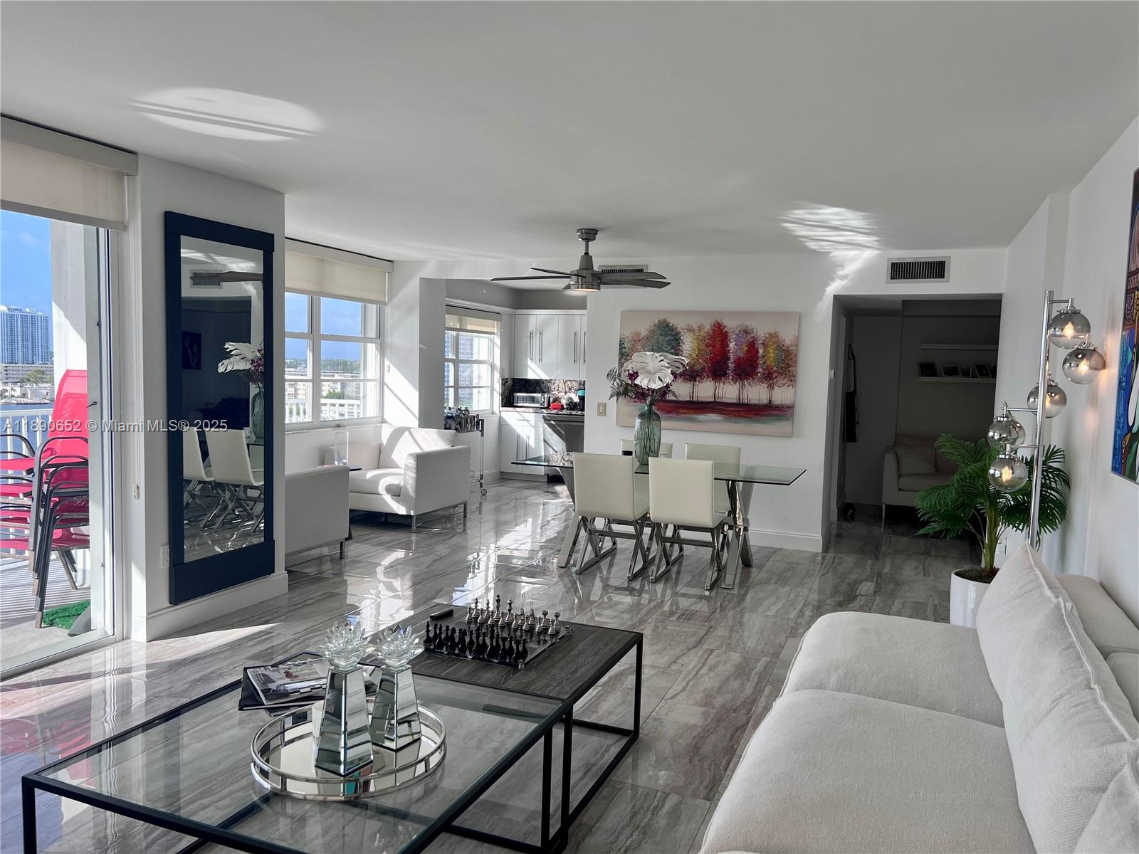 2851 Northeast 183rd Street, Unit 1017E Aventura, FL 33160 - Photo 10 of 46 a living room with furniture and a painting on the wall