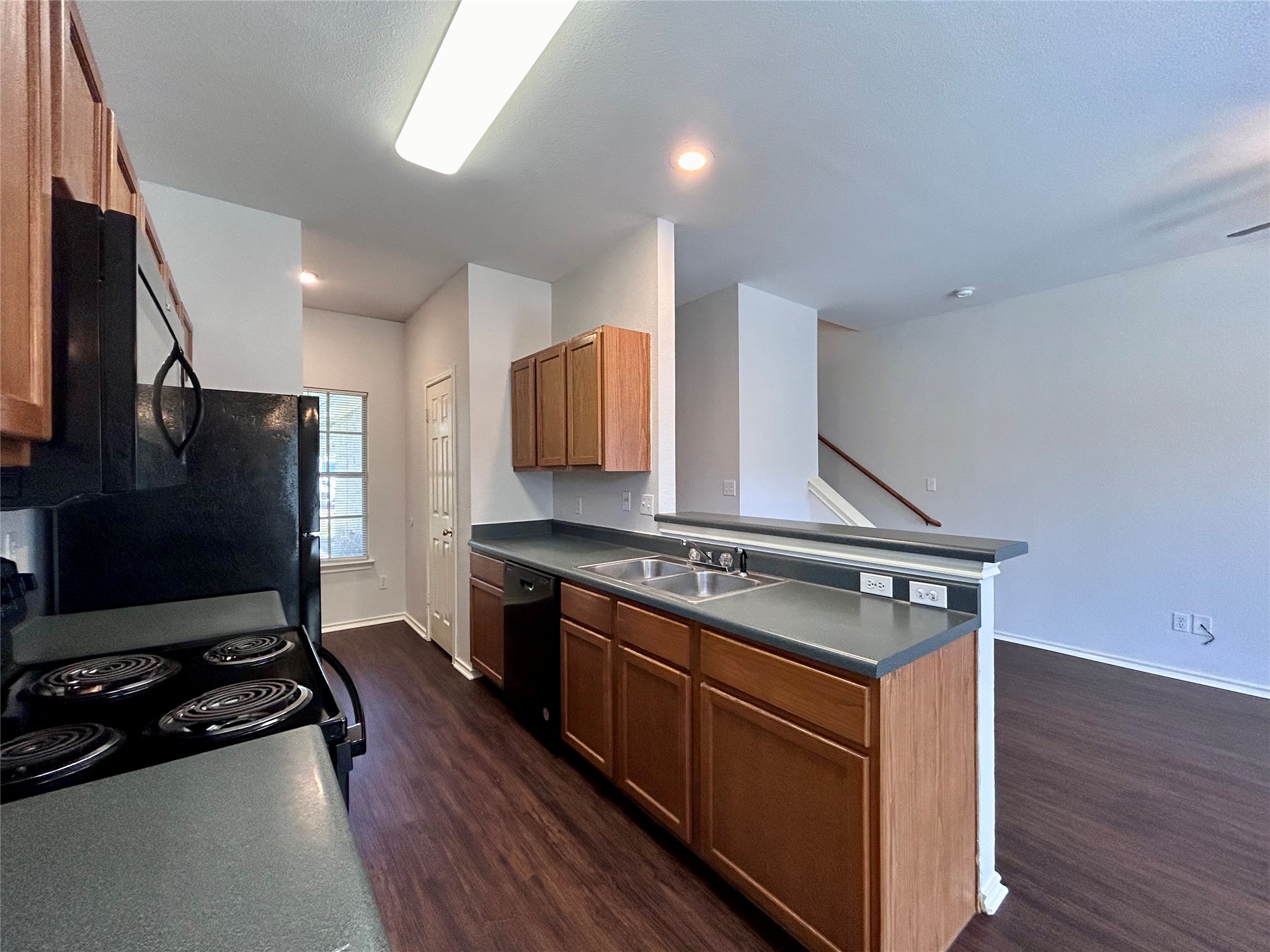 12307 Abney Drive Austin, TX 78729 - Photo 3 of 18 a kitchen with wooden floor and a stove