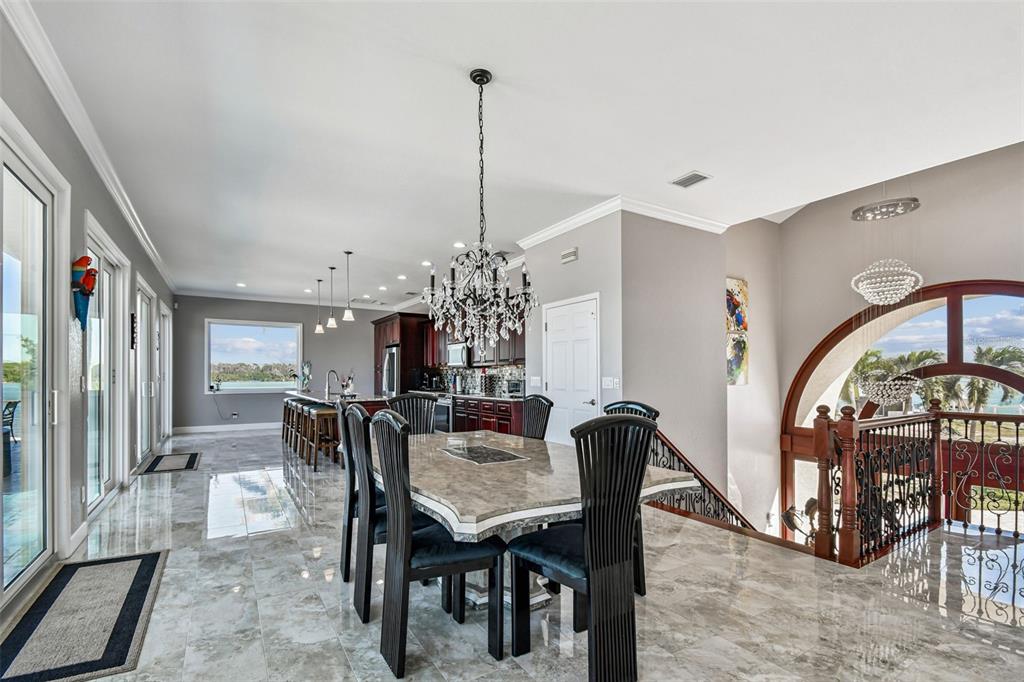 582 Johns Pass Avenue Madeira Beach, FL 33708 - Photo 17 of 100 a view of a dining room with furniture and a chandelier