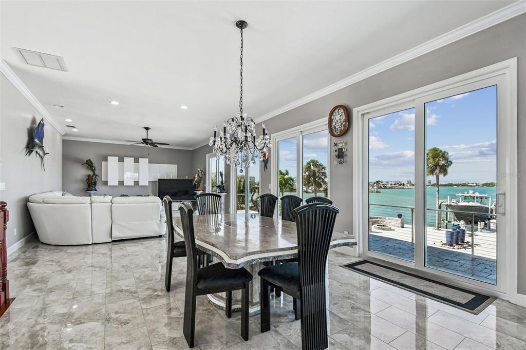 582 Johns Pass Avenue Madeira Beach, FL 33708 - Photo 19 of 100 a dining room with furniture a chandelier and window