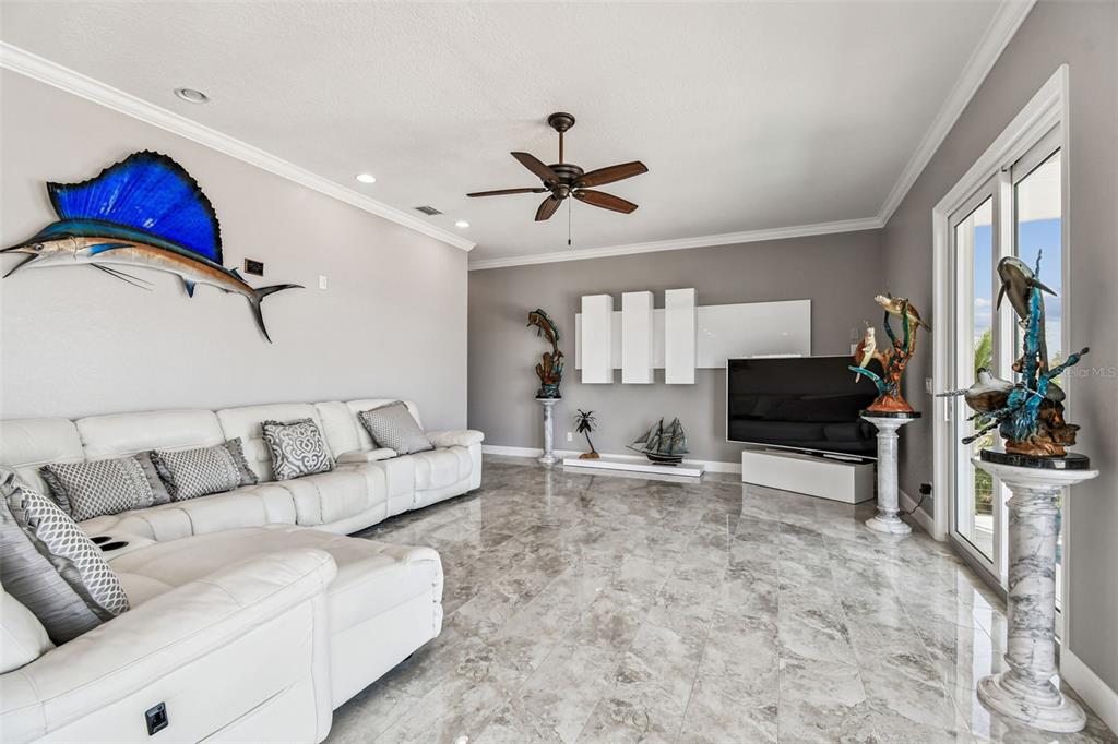 582 Johns Pass Avenue Madeira Beach, FL 33708 - Photo 28 of 100 a living room with furniture and a flat screen tv