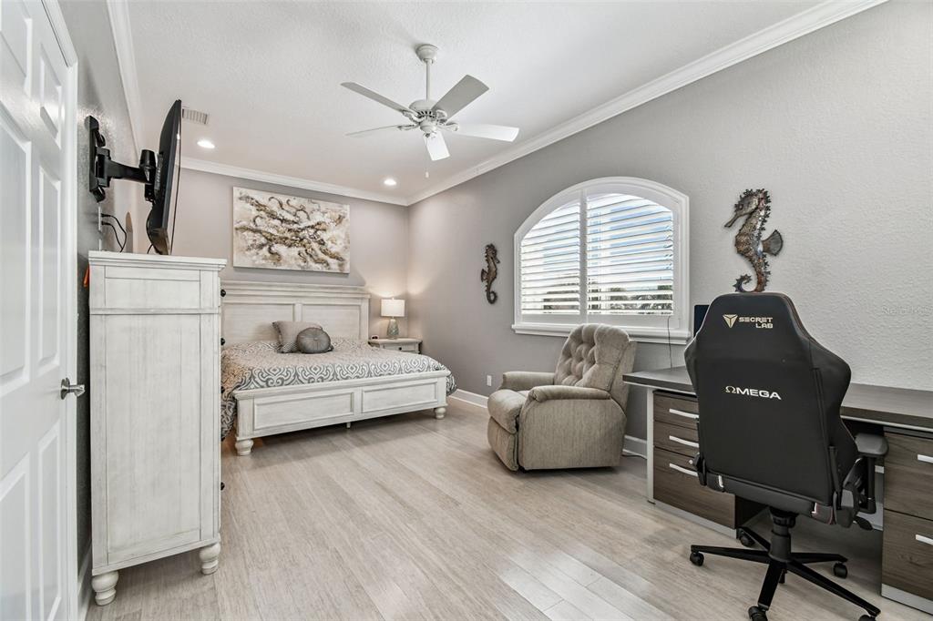 582 Johns Pass Avenue Madeira Beach, FL 33708 - Photo 52 of 100 a bedroom with a bed and wooden floor