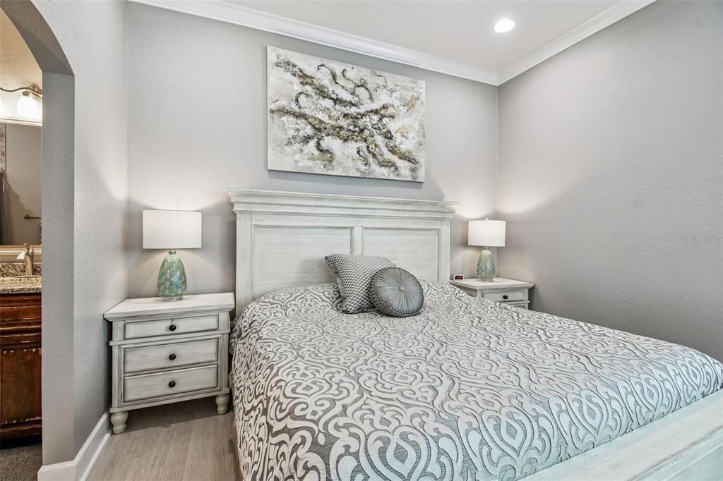 582 Johns Pass Avenue Madeira Beach, FL 33708 - Photo 56 of 100 a bedroom with a bed and a night stand