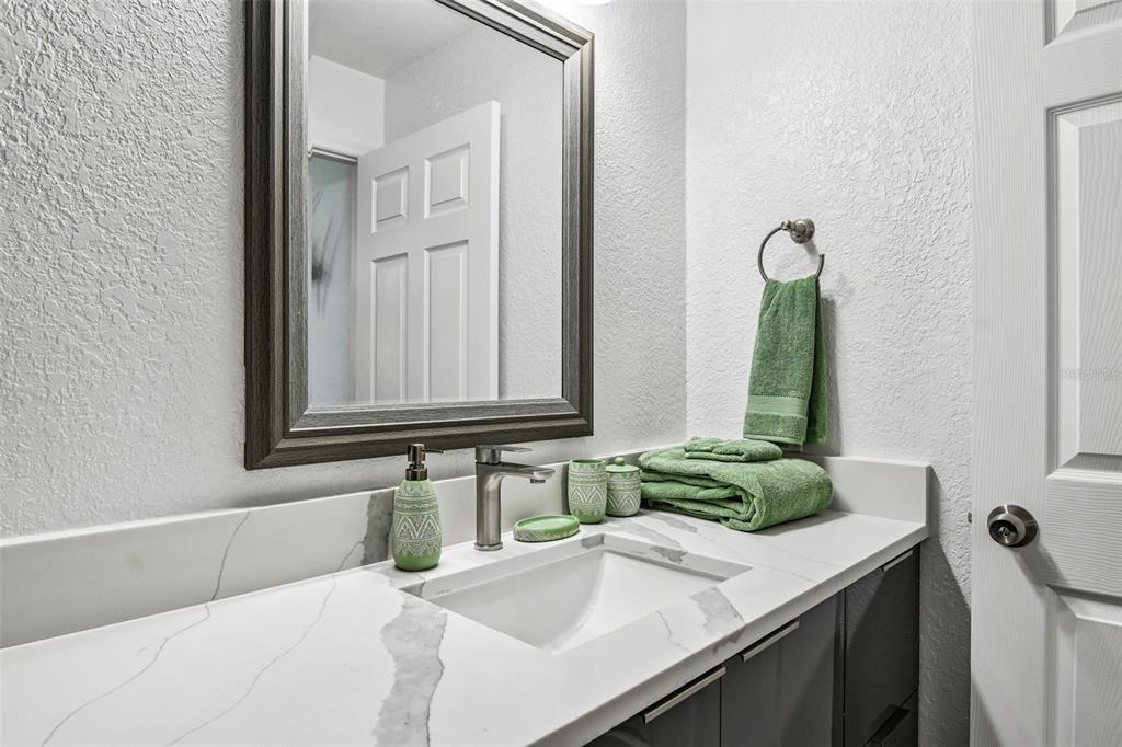 582 Johns Pass Avenue Madeira Beach, FL 33708 - Photo 65 of 100 a bathroom with a sink and a mirror