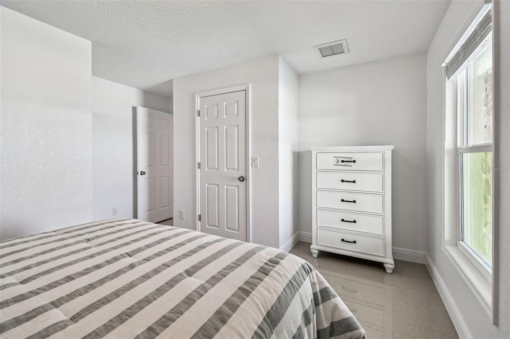 582 Johns Pass Avenue Madeira Beach, FL 33708 - Photo 68 of 100 a bedroom with a bed and a dresser