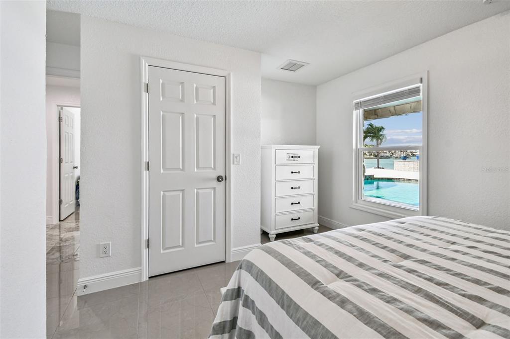 582 Johns Pass Avenue Madeira Beach, FL 33708 - Photo 69 of 100 a bedroom with a bed and a window