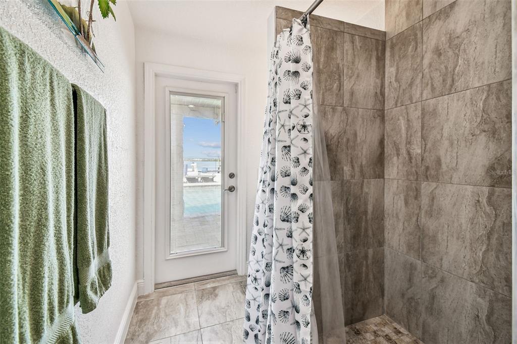 582 Johns Pass Avenue Madeira Beach, FL 33708 - Photo 70 of 100 a bathroom with a shower and a sink