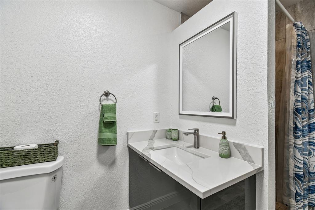 582 Johns Pass Avenue Madeira Beach, FL 33708 - Photo 84 of 100 a bathroom with a sink and a mirror