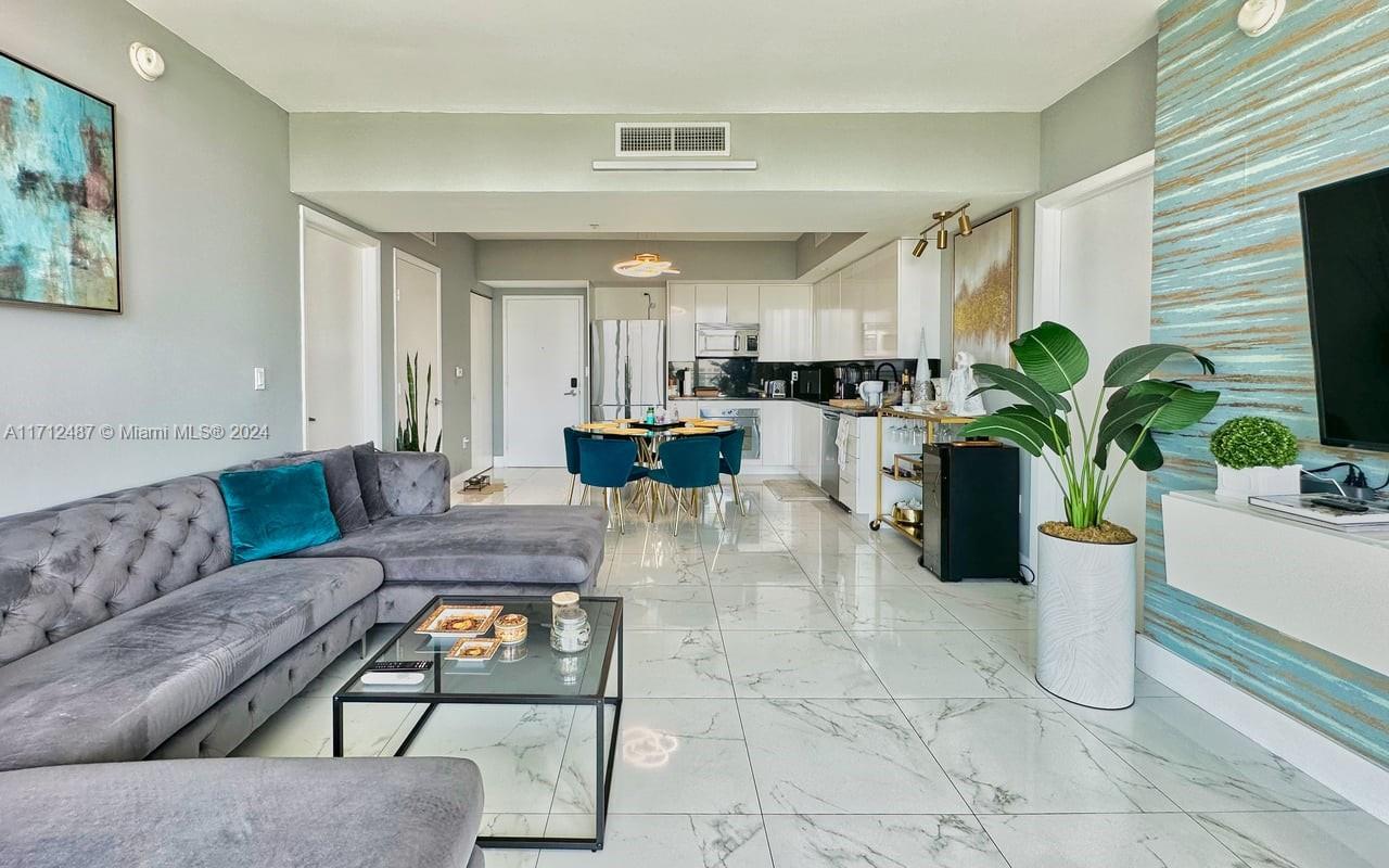 a living room with furniture and a potted plant