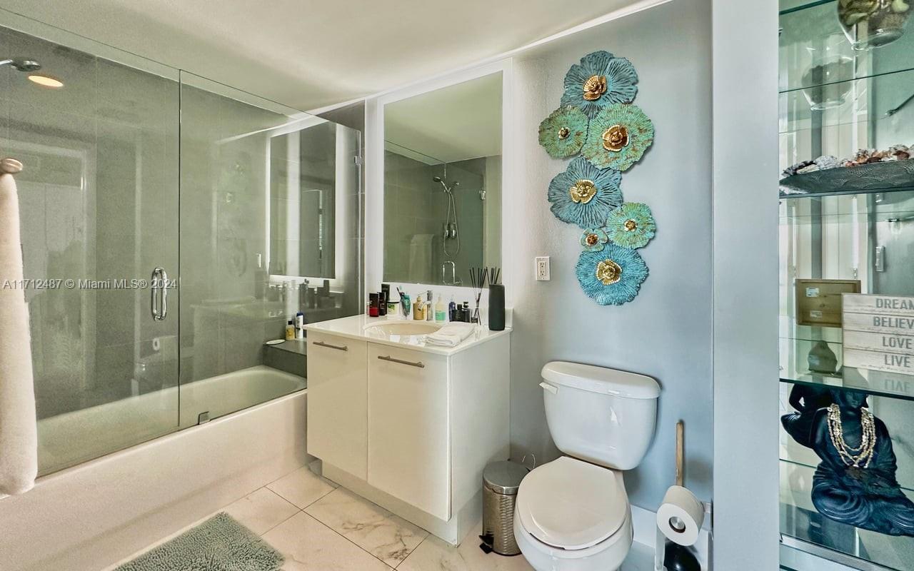 92 Southwest 3rd Street, Unit 4411 Miami, FL 33130 - Photo 14 of 17 a bathroom with a toilet sink and shower