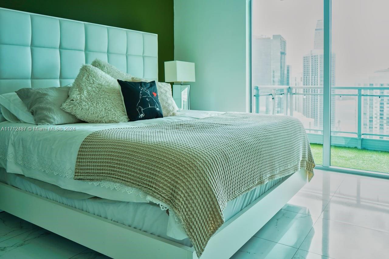92 Southwest 3rd Street, Unit 4411 Miami, FL 33130 - Photo 5 of 17 a bedroom with a bed and a large window