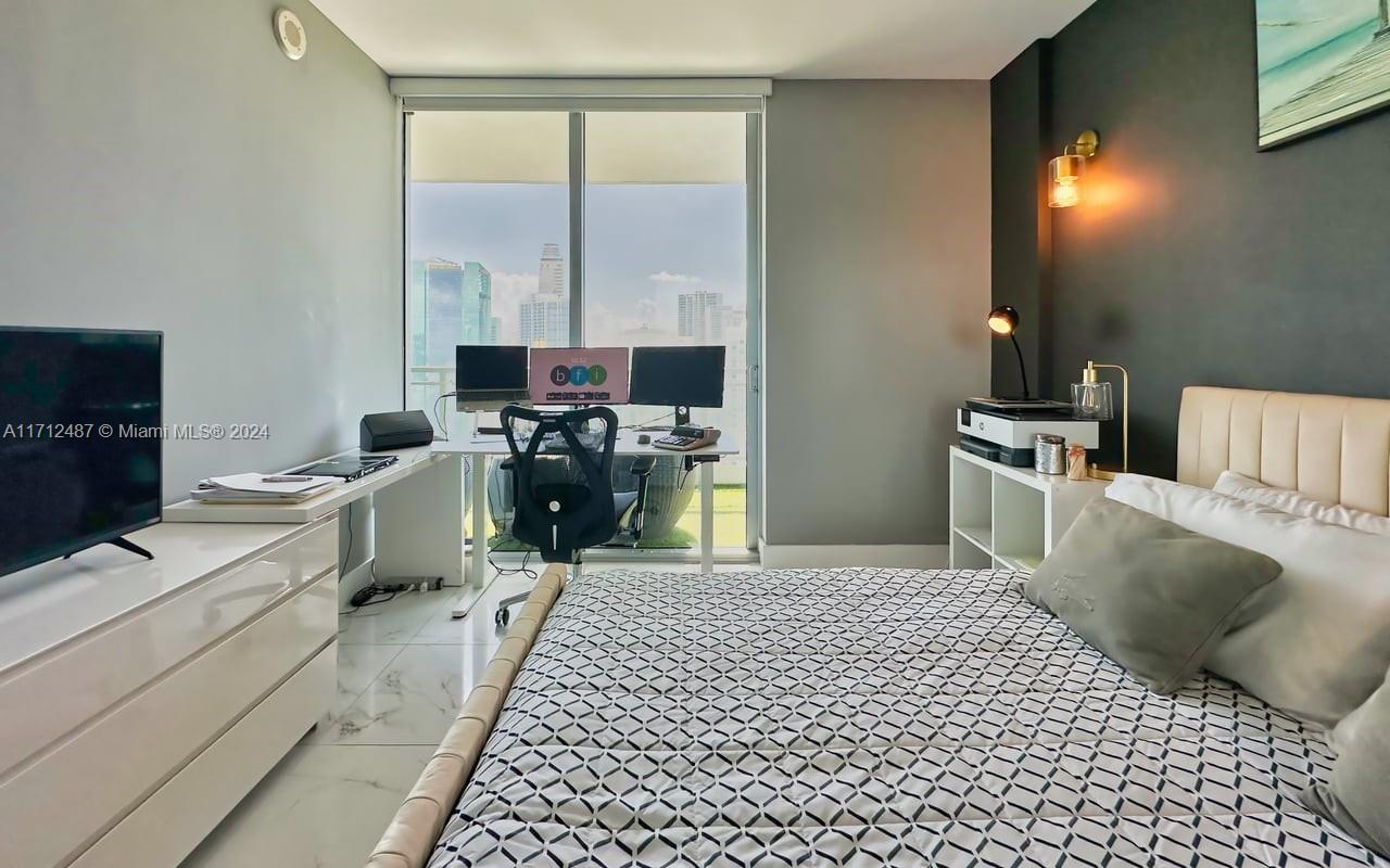 92 Southwest 3rd Street, Unit 4411 Miami, FL 33130 - Photo 8 of 17 a kitchen with a sink cabinets and appliances