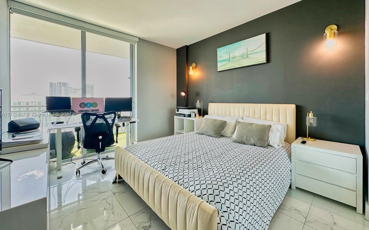 92 Southwest 3rd Street, Unit 4411 Miami, FL 33130 - Photo 9 of 17 a bed room with a bed and a chair