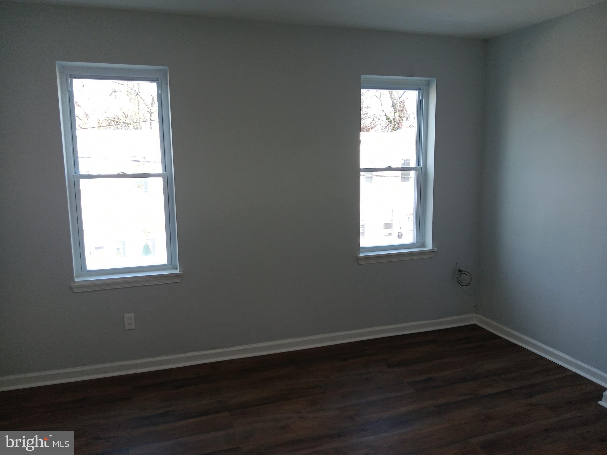 1012 Potter Street Chester, PA 19013 - Photo 11 of 19 an empty room with wooden floor and a window