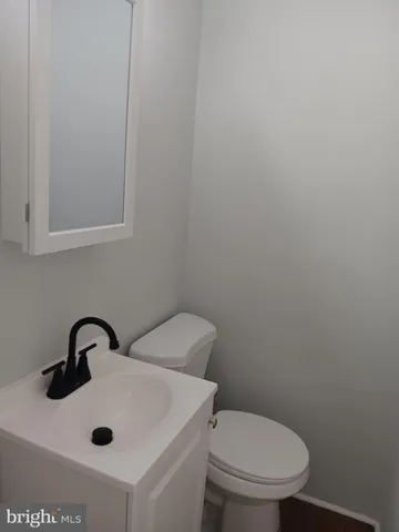 a bathroom with a sink a toilet and mirror
