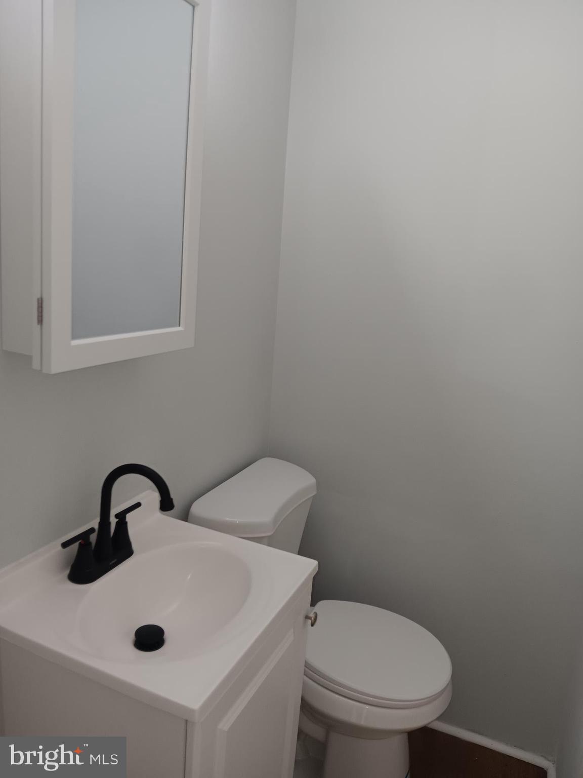 1012 Potter Street Chester, PA 19013 - Photo 14 of 19 a bathroom with a sink a toilet and mirror