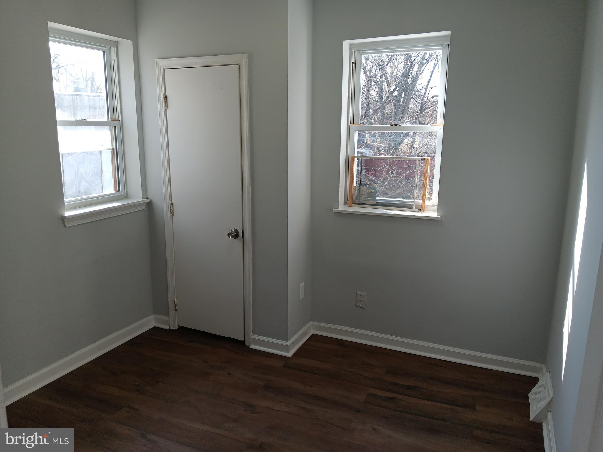 1012 Potter Street Chester, PA 19013 - Photo 16 of 19 an empty room with wooden floor and windows