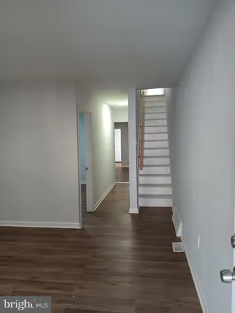 a view of a room with wooden floors and stairs