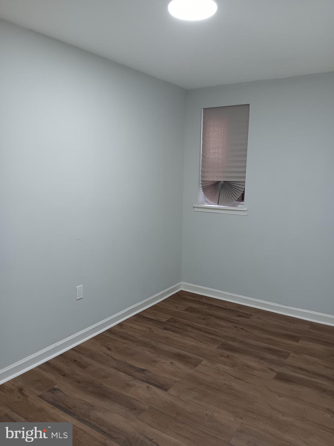 1012 Potter Street Chester, PA 19013 - Photo 5 of 19 a view of an empty room with wooden floor and a window