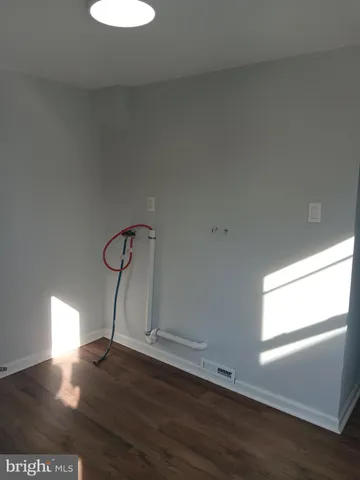 a room with a window and wooden floor