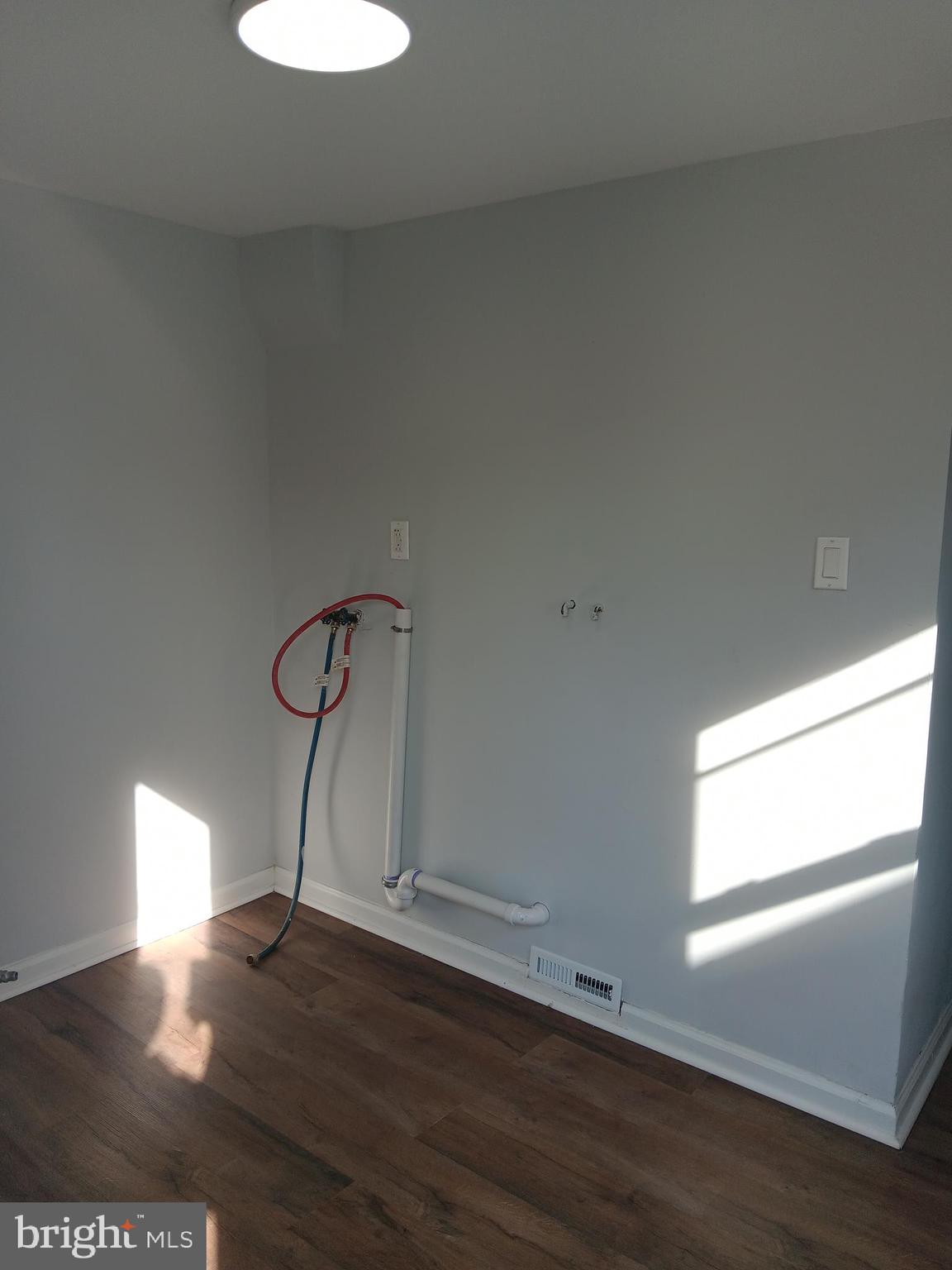 1012 Potter Street Chester, PA 19013 - Photo 7 of 19 a room with a window and wooden floor