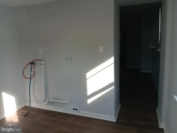 a view of a room with wooden floor