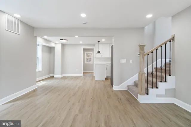 a view of a hallway with wooden floor and entryway