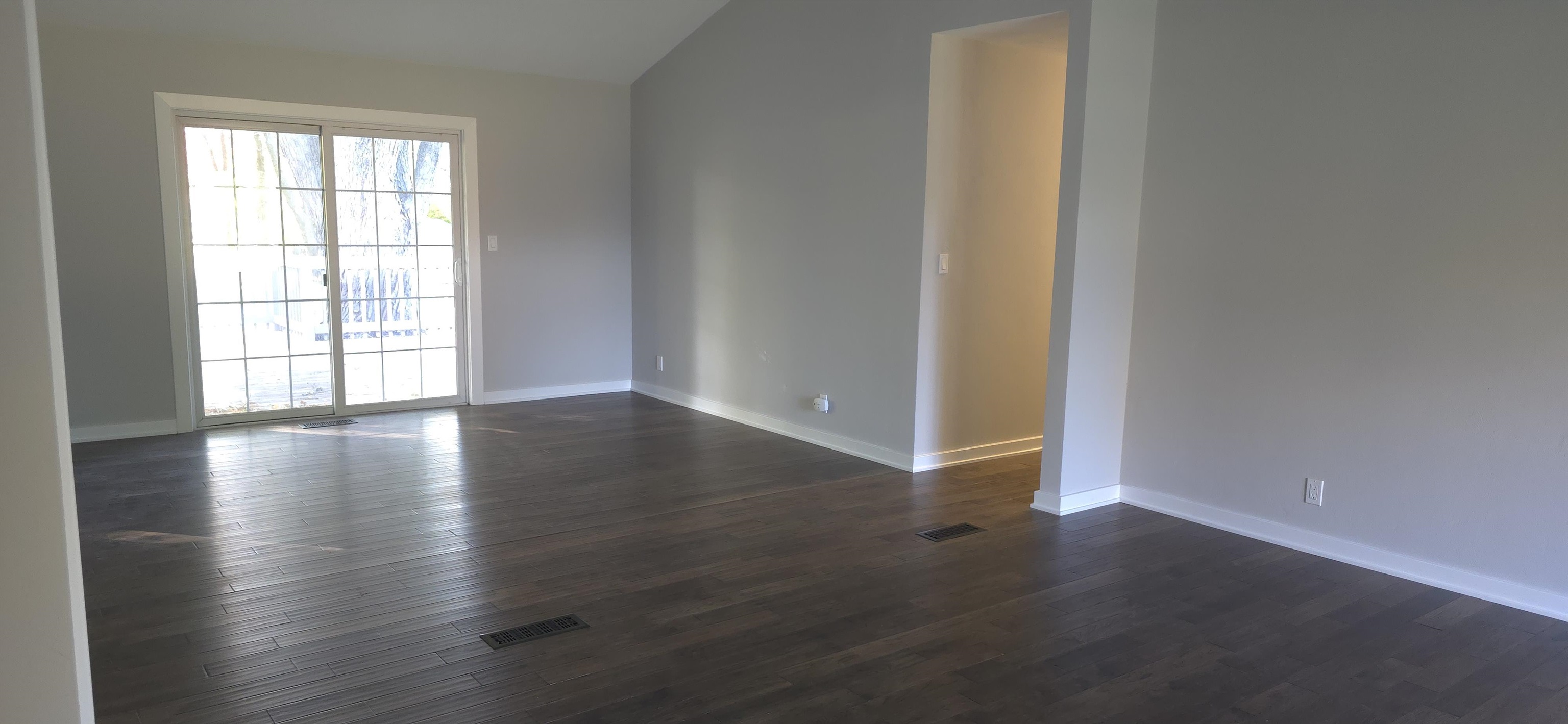 3606 Springwheat Street Rockford, IL 61114 - Photo 14 of 41 an empty room with wooden floor and windows with curtains