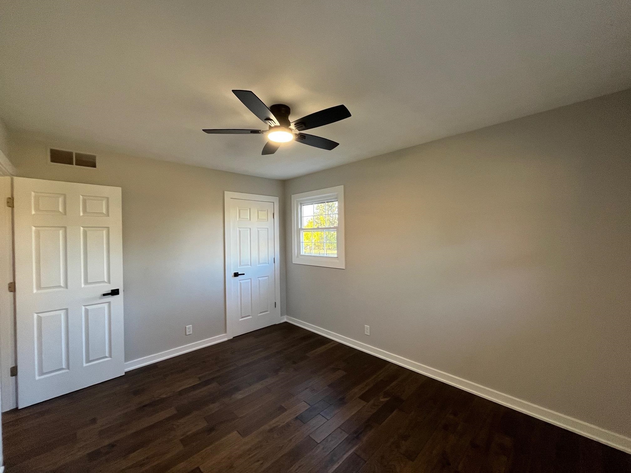 3606 Springwheat Street Rockford, IL 61114 - Photo 25 of 41 an empty room with wooden floor and windows