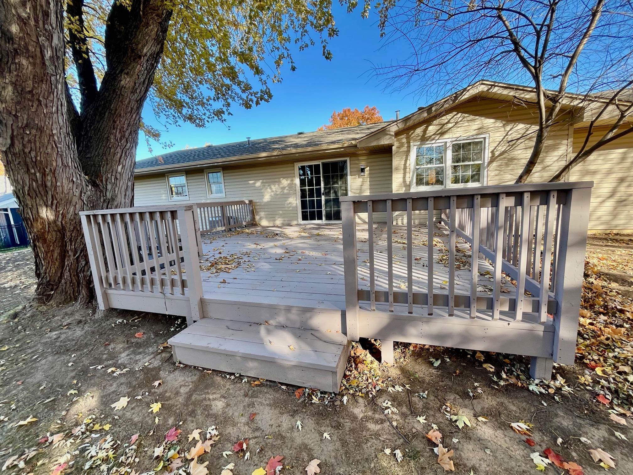 3606 Springwheat Street Rockford, IL 61114 - Photo 37 of 41 a view of a house with a wooden deck and a yard