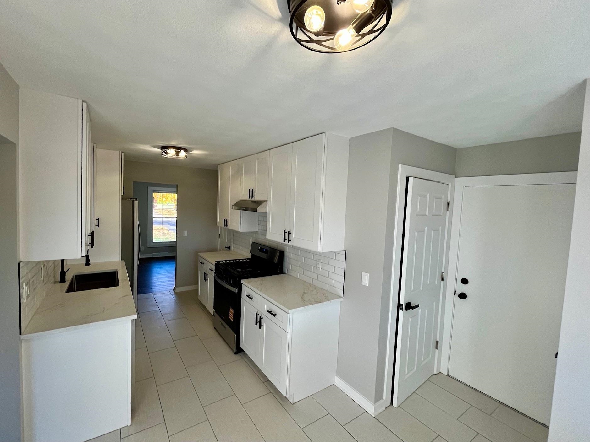 3606 Springwheat Street Rockford, IL 61114 - Photo 4 of 41 a kitchen with stainless steel appliances granite countertop a refrigerator and a stove top oven