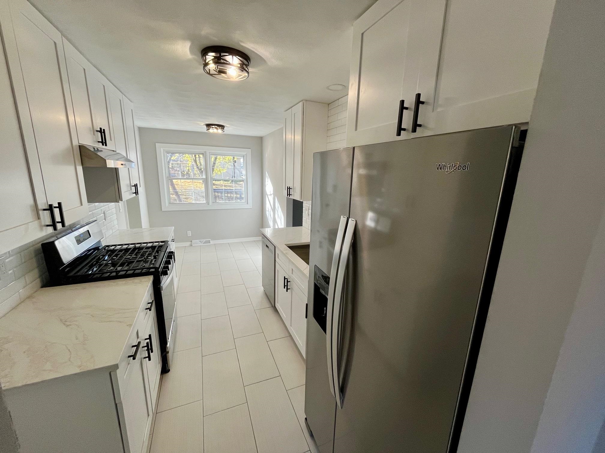 3606 Springwheat Street Rockford, IL 61114 - Photo 6 of 41 a kitchen with stainless steel appliances a refrigerator a sink a stove a washer dryer and a refrigerator