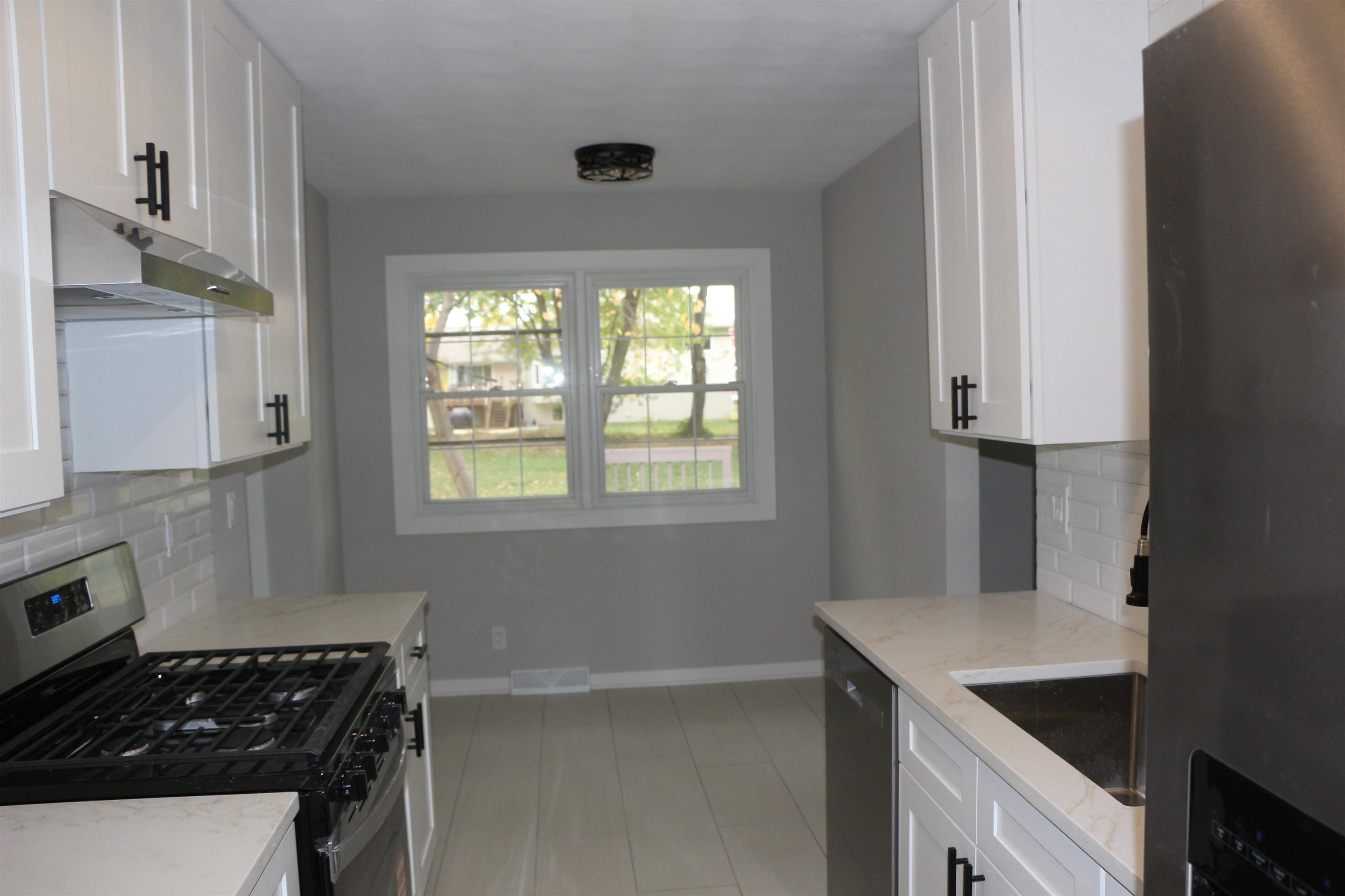 3606 Springwheat Street Rockford, IL 61114 - Photo 7 of 41 a kitchen with granite countertop a sink stove and cabinets