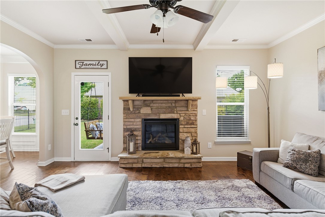 138 Buckland Drive Anderson, SC 29621 - Photo 9 of 49 This inviting living room features a fireplace, ceiling fan, and hardwood floors.