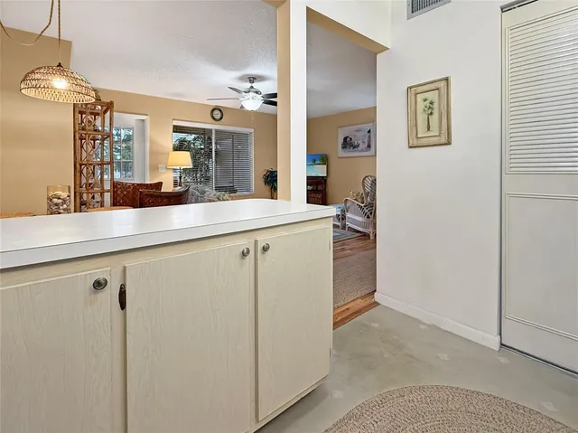 a view with granite countertop cabinets and white appliances