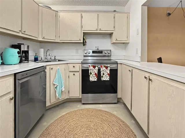 a kitchen with stainless steel appliances granite countertop a refrigerator sink and cabinets