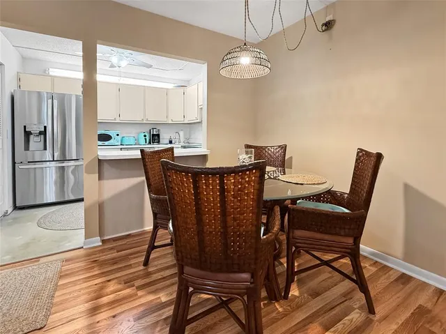 a view of a dining room with furniture and wooden floor