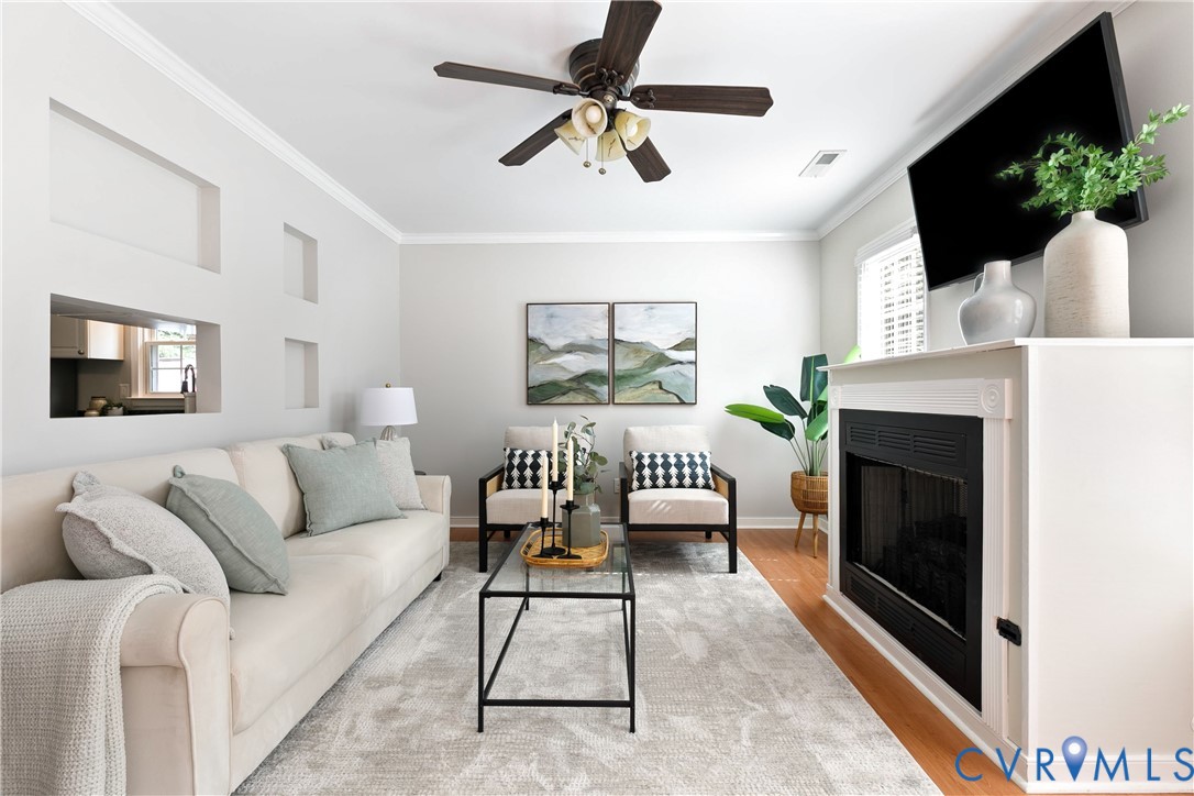 Bright, open living room featuring hardwood floori