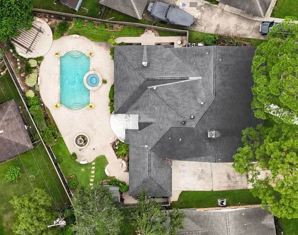 an aerial view of residential house with outdoor space and parking