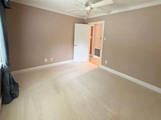 en empty room with windows and fan