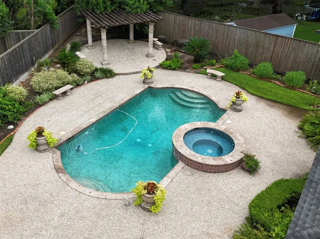 a view of a backyard with plants and outdoor seating