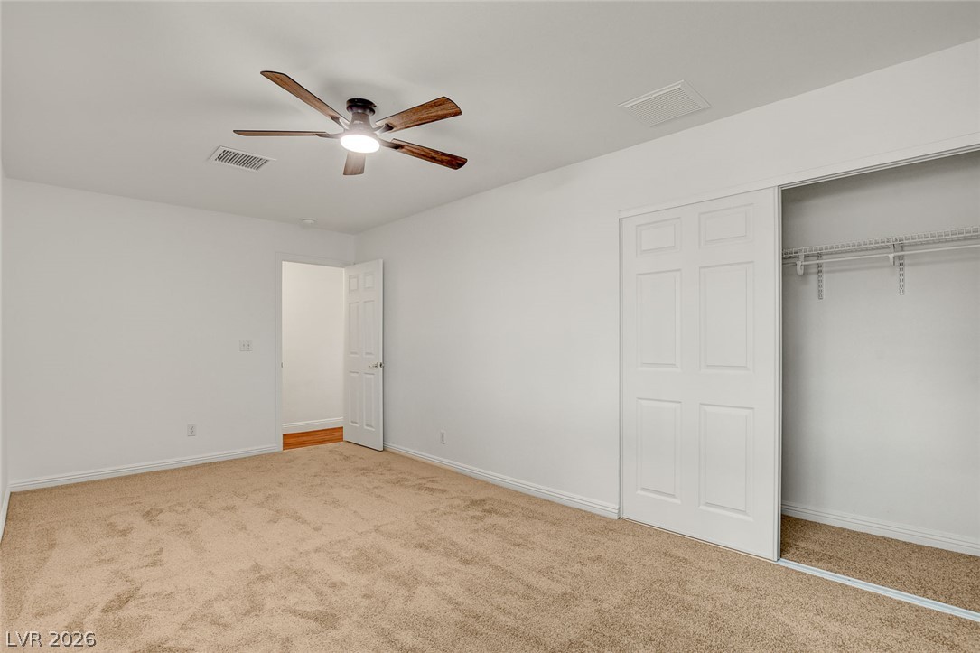 1810 Pinto Road Henderson, NV 89002 - Photo 33 of 53 A spacious chamber awaits, complete with a ceiling fan for comfort and an accessible closet.