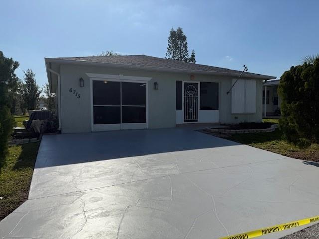 a front view of a house with a yard and a garage